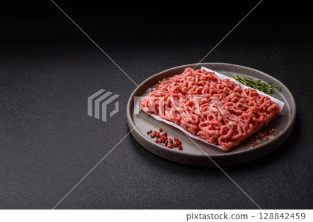 Raw ground beef or pork as an ingredient for burgers. Raw minced meat 128842459