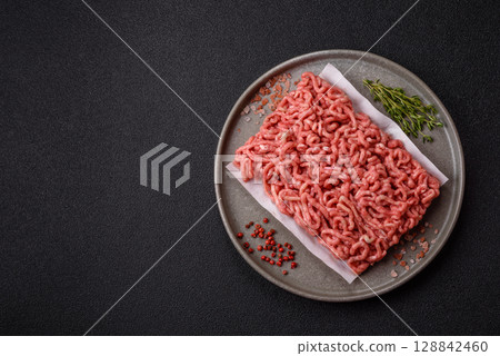 Raw ground beef or pork as an ingredient for burgers. Raw minced meat Raw ground beef or pork as an ingredient for burgers. Raw minced meat 128842460