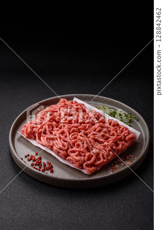 Raw ground beef or pork as an ingredient for burgers. Raw minced meat 128842462