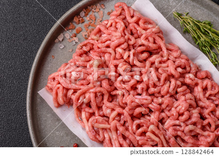 Raw ground beef or pork as an ingredient for burgers. Raw minced meat 128842464