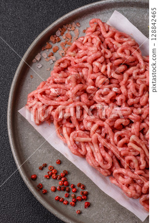 Raw ground beef or pork as an ingredient for burgers. Raw minced meat Raw ground beef or pork as an ingredient for burgers. Raw minced meat 128842465