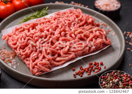 Raw ground beef or pork as an ingredient for burgers. Raw minced meat 128842467