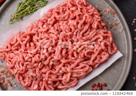 Raw ground beef or pork as an ingredient for burgers. Raw minced meat 128842468