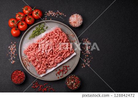 Raw ground beef or pork as an ingredient for burgers. Raw minced meat 128842472