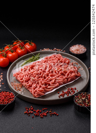 Raw ground beef or pork as an ingredient for burgers. Raw minced meat 128842474