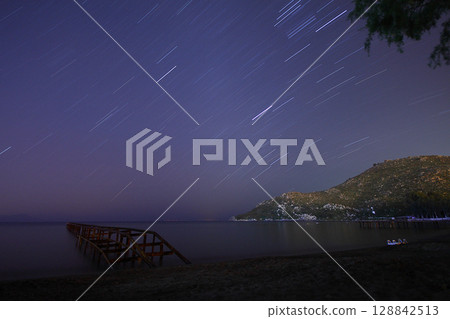 A view of the stars of the Milky Way with a mountain top in the foreground.Perseid Meteor Shower observation 128842513