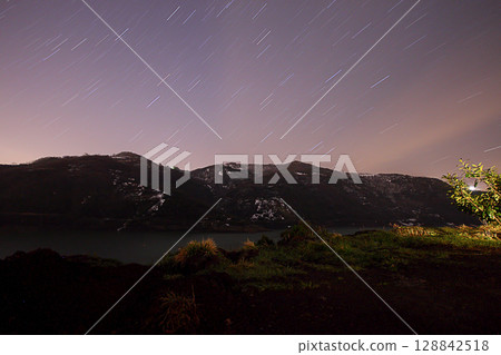 A view of the stars of the Milky Way with a mountain top in the foreground.Perseid Meteor Shower observation A view of the stars of the Milky Way with a mountain top in the foreground.Perseid Meteor Shower observation 128842518