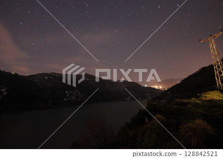 A view of the stars of the Milky Way with a mountain top in the foreground.Perseid Meteor Shower observation 128842521
