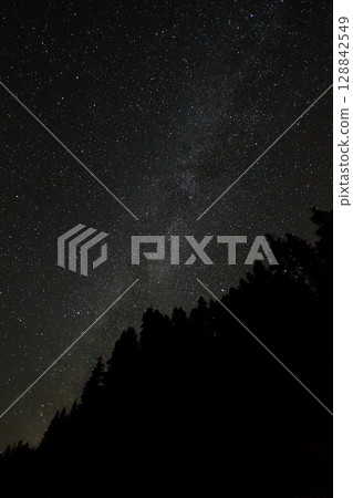 A view of the stars of the Milky Way with a mountain top in the foreground.Perseid Meteor Shower observation 128842549