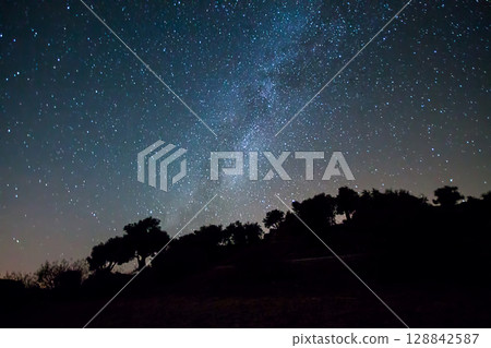 A view of the stars of the Milky Way with a mountain top in the foreground.Perseid Meteor Shower observation 128842587