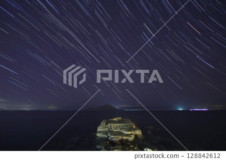 A view of the stars of the Milky Way with a mountain top in the foreground.Perseid Meteor Shower observation 128842612
