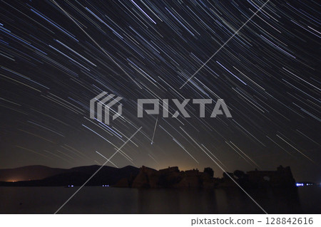 A view of the stars of the Milky Way with a mountain top in the foreground.Perseid Meteor Shower observation 128842616