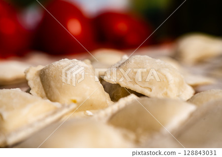 Fresh homemade uncooked ravioli pasta sprinkled with flour 128843031