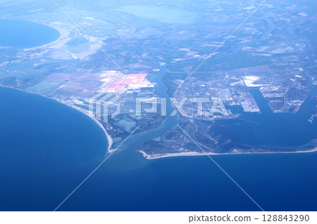 Aerial Coastal View with Rivers, Lands, and Ocean Surrounding Industrial Areas Aerial Coastal View with Rivers, Lands, and Ocean Surrounding Industrial Areas 128843290