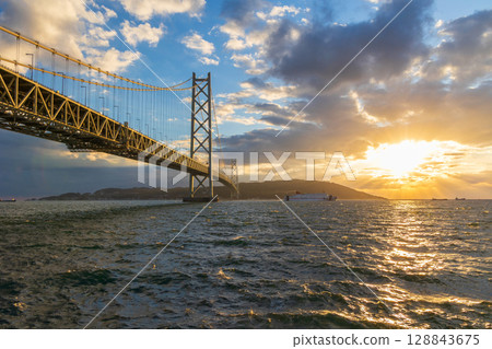 Sunset at Akashi Kaikyo Bridge, one of the world's largest suspension bridges 128843675