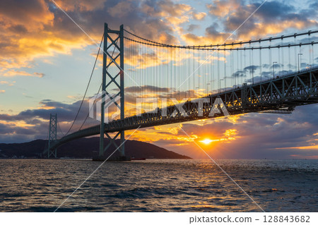 Sunset at Akashi Kaikyo Bridge, one of the world's largest suspension bridges Sunset at Akashi Kaikyo Bridge, one of the world's largest suspension bridges 128843682