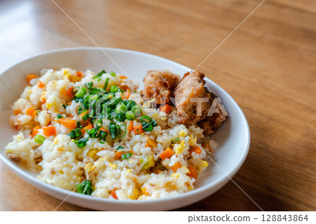 A colorful lunch of fried rice and fried chicken A colorful lunch of fried rice and fried chicken 128843864