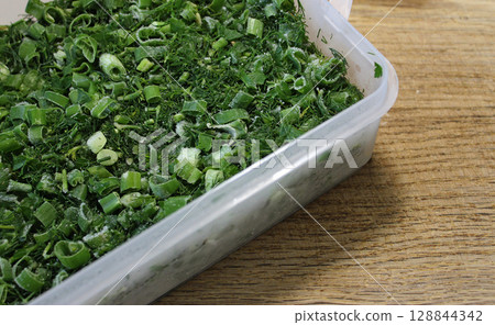 Domestic Cooking Recipes. Plastic Tray With Defrosted Variety Chopped Greens In A Chopping Board Domestic Cooking Recipes. Plastic Tray With Defrosted Variety Chopped Greens In A Chopping Board 128844342