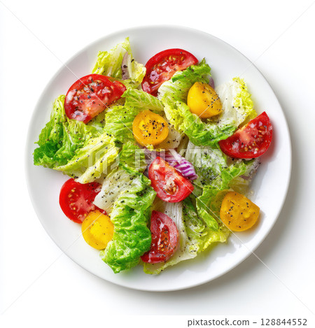 Fresh garden salad featuring crisp green lettuce, red, yellow cherry tomato halves, purple onion, black pepper and herbs, presented on a clean white plate against a white background. 128844552