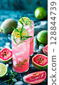 Tropical guava spritz with herbs in minimal beachside scene, styled for summer wellness and coastal calm 128844739