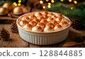 Classic tiramisu with cocoa and pine branches, soft fairy lights, cozy winter holiday mood 128844885
