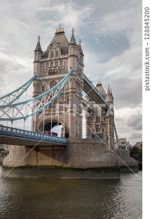 A low-angle view of London's iconic Tower Bridge (bascule and suspension bridge). A low-angle view of London's iconic Tower Bridge (bascule and suspension bridge). 128845200