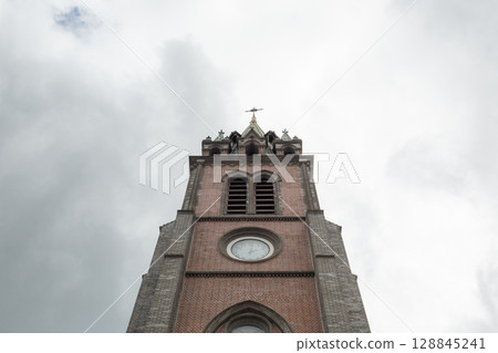 [South Korea] Brick exterior and cloudy sky inside Myeongdong Cathedral in Seoul 128845241