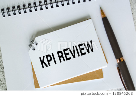 Key Performance Indicator text on white notepad. Business KPI concept Key Performance Indicator text on white notepad. Business KPI concept 128845268