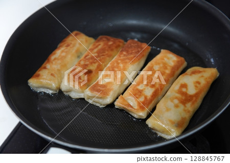 Deep-frying spring rolls 128845767