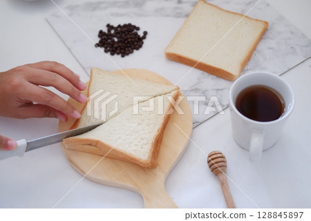 Cutting Toast for Breakfast 128845897