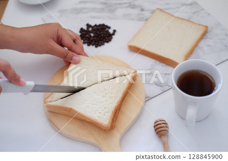 Cutting Toast for Breakfast 128845900