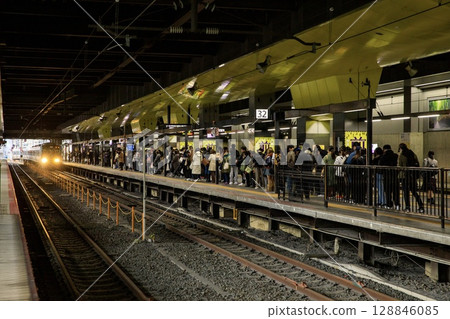 The Sagano Line platform at Kyoto Station is crowded with passengers. The Sagano Line platform at Kyoto Station is crowded with passengers. 128846085
