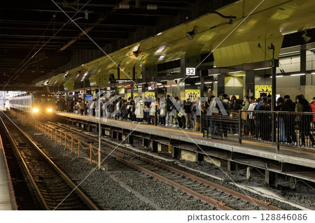 The Sagano Line platform at Kyoto Station is crowded with passengers. The Sagano Line platform at Kyoto Station is crowded with passengers. 128846086