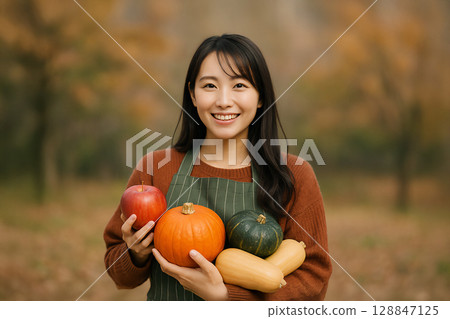 Image of autumn appetite: A smiling woman holding seasonal ingredients 128847125
