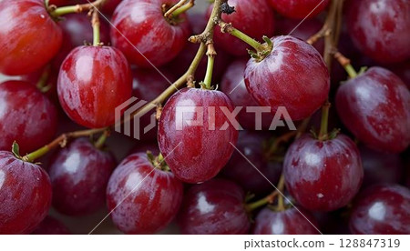A detailed view of red grapes, highlighting their glossy skin and natural pattern in a spring setting 128847319