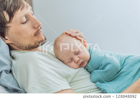 Newborn baby peacefully sleeps on father chest in a quiet bonding moment, representing love, security, and emotional connection in early fatherhood and family life Newborn baby peacefully sleeps on father chest in a quiet bonding moment, representing love, security, and emotional connection in early fatherhood and family life 128848092