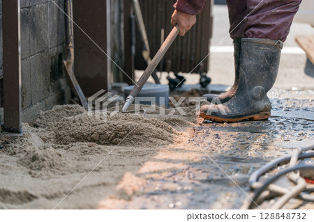 建築工人用耙子平整沙子 建築工人用耙子平整沙子 128848732