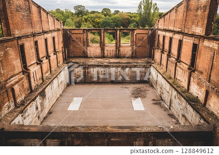 High-Angle View of a Ruined Brick Factory Interior 128849612