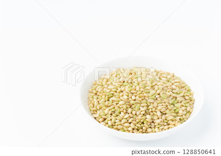 Green rice in a plate on a white background 128850641