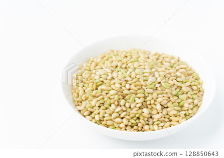 Green rice in a plate on a white background 128850643