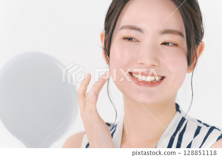 A young woman doing skin care 128851118