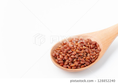 Close-up of red rice on a spoon on a white background 128852240