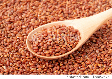 Close-up of red rice on a spoon 128852376