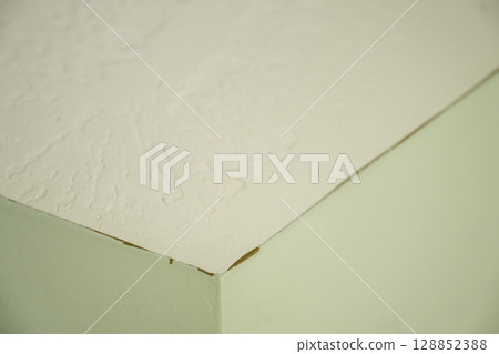 Missed corner section where old paint is visible through the new coat overlap.  128852388