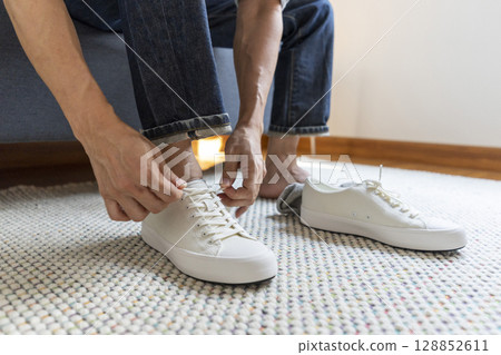 Young man dress shoes at home Young man dress shoes at home 128852611