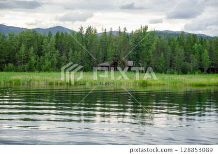Remote Cabin Hidden in Forest by Quiet Lake Remote Cabin Hidden in Forest by Quiet Lake 128853089