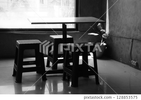 Simple Black and White Scene with Minimalist Furniture and Natural Light Simple Black and White Scene with Minimalist Furniture and Natural Light 128853575