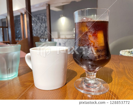 Iced coffee in a glass; cold coffee with ice. Iced coffee in a glass; cold coffee with ice. 128853772