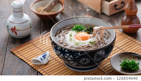 Steaming grated yam soba noodles Japanese style soba dish with egg yolk and spring onion Steaming grated yam soba noodles Japanese style soba dish with egg yolk and spring onion 128854040