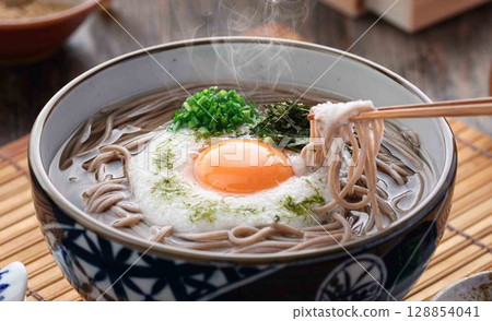 Steaming grated yam soba noodles Japanese style soba dish with egg yolk and spring onion Steaming grated yam soba noodles Japanese style soba dish with egg yolk and spring onion 128854041